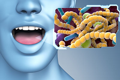 The image shows a 3D animated human head with an open mouth, displaying a microscopic view of bacteria within the mouth cavity on a computer screen.