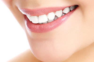 The image shows a close-up of a person s face with a focus on their teeth and lips, highlighting dental care or cosmetic enhancement.