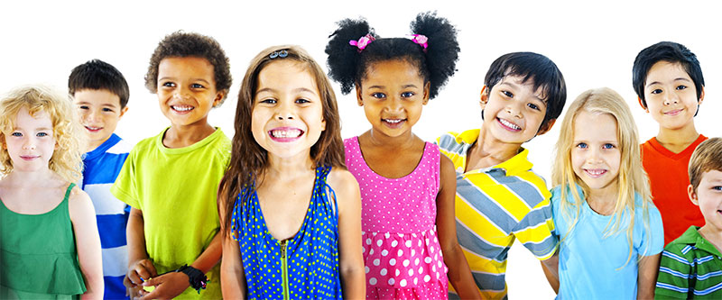 The image shows a group of children standing together, with each child wearing different colored shirts, against a white background.